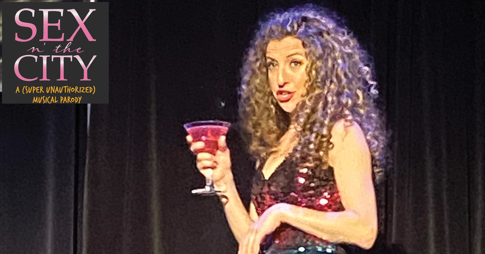 A woman speaking while holding a martini glass.