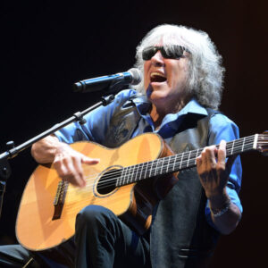 José Feliciano playing guitar at the microphone