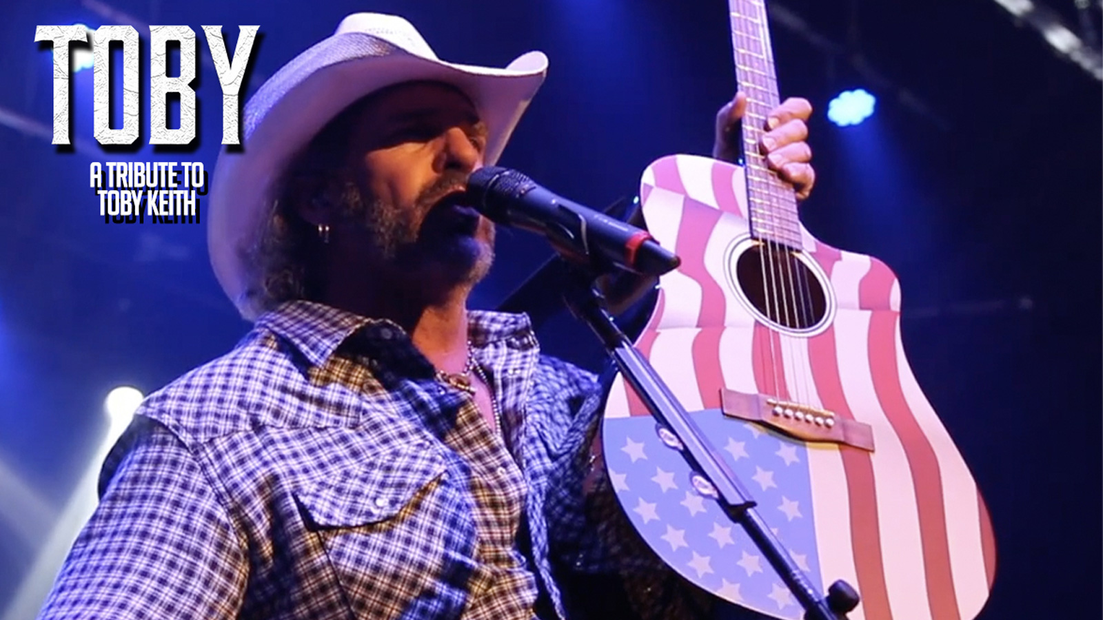 Hollywood Yates playing guitar as Toby Keith