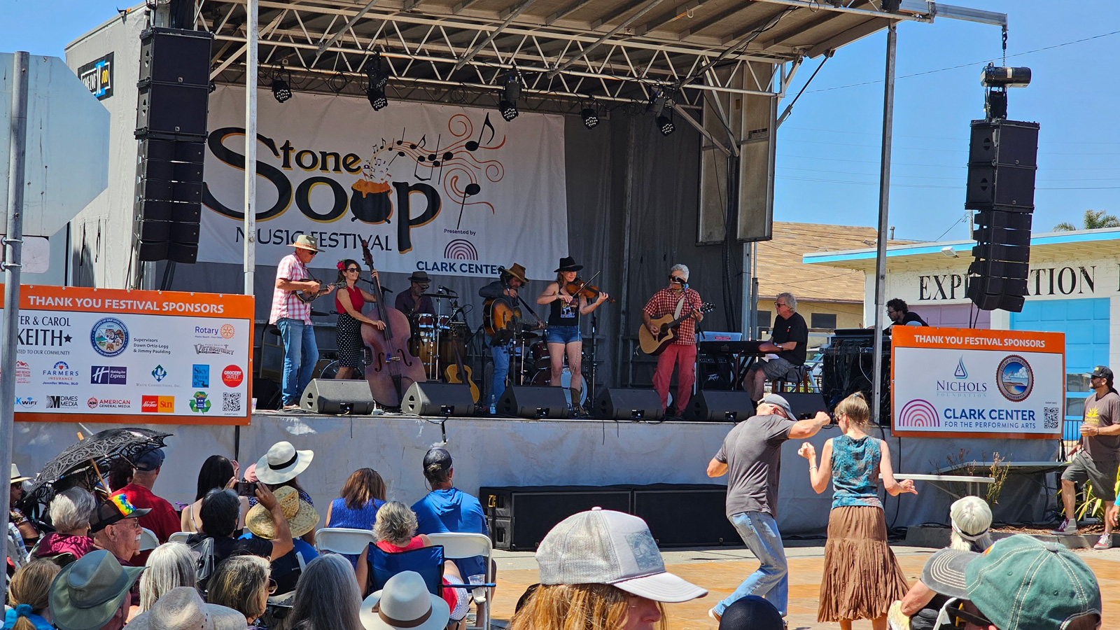 Stone Soup Street Stage with band playing and crowd dancing.