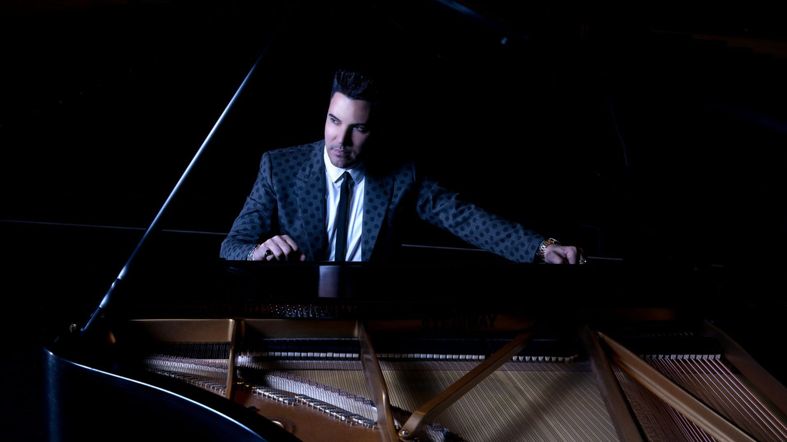 Frankie Moreno seated at the piano.