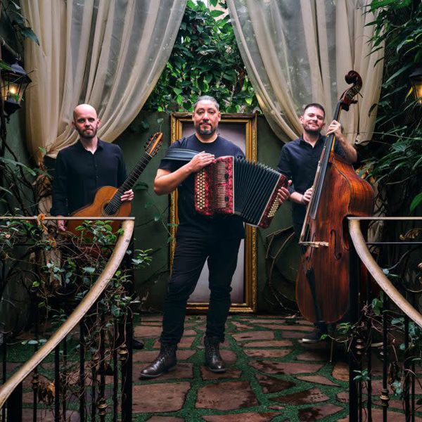 Members of Alejandro Brittes Trio posing with instruments.