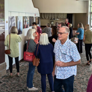Guests mingling at an artists reception.