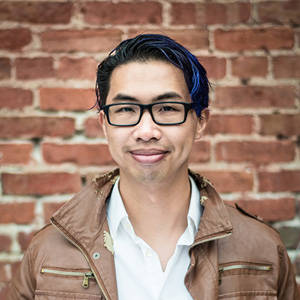 K. Cheng in front of a brick wall