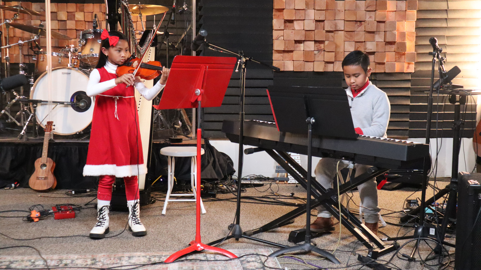 Two young musicians playing strings and piano