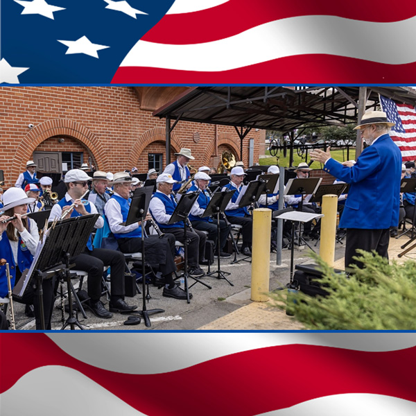 Members of the SLO County Band playing at a concert outdoors